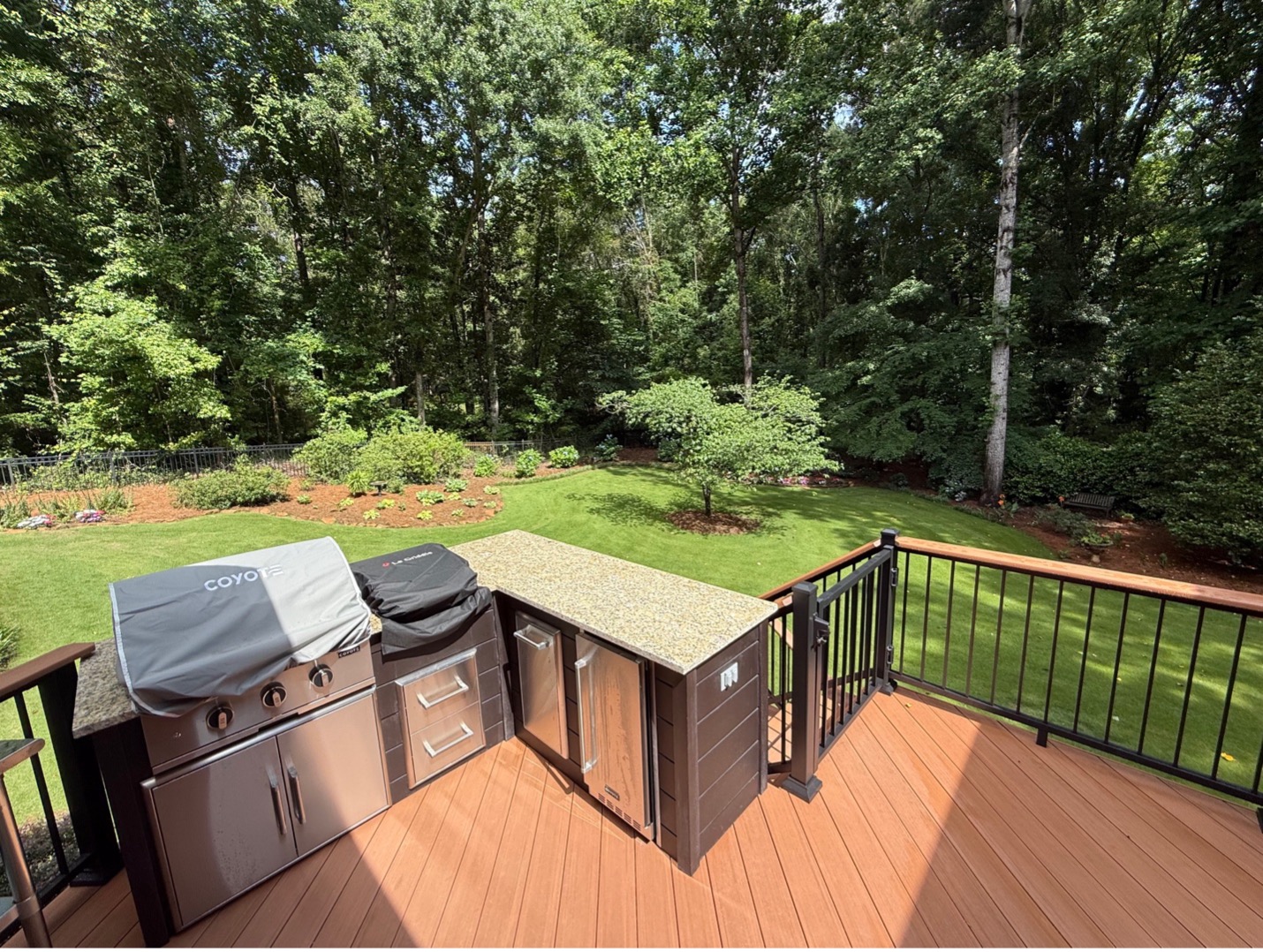 porch and deck combination space with integrated outdoor kitchen